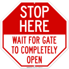 Stop Here Wait For Gate To Completely Open Sign
